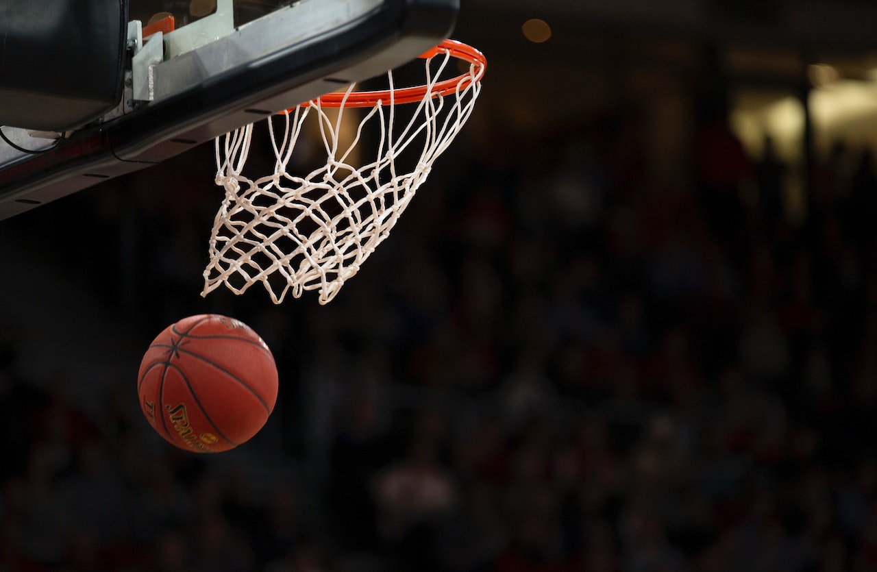 shooting basketball through hoop