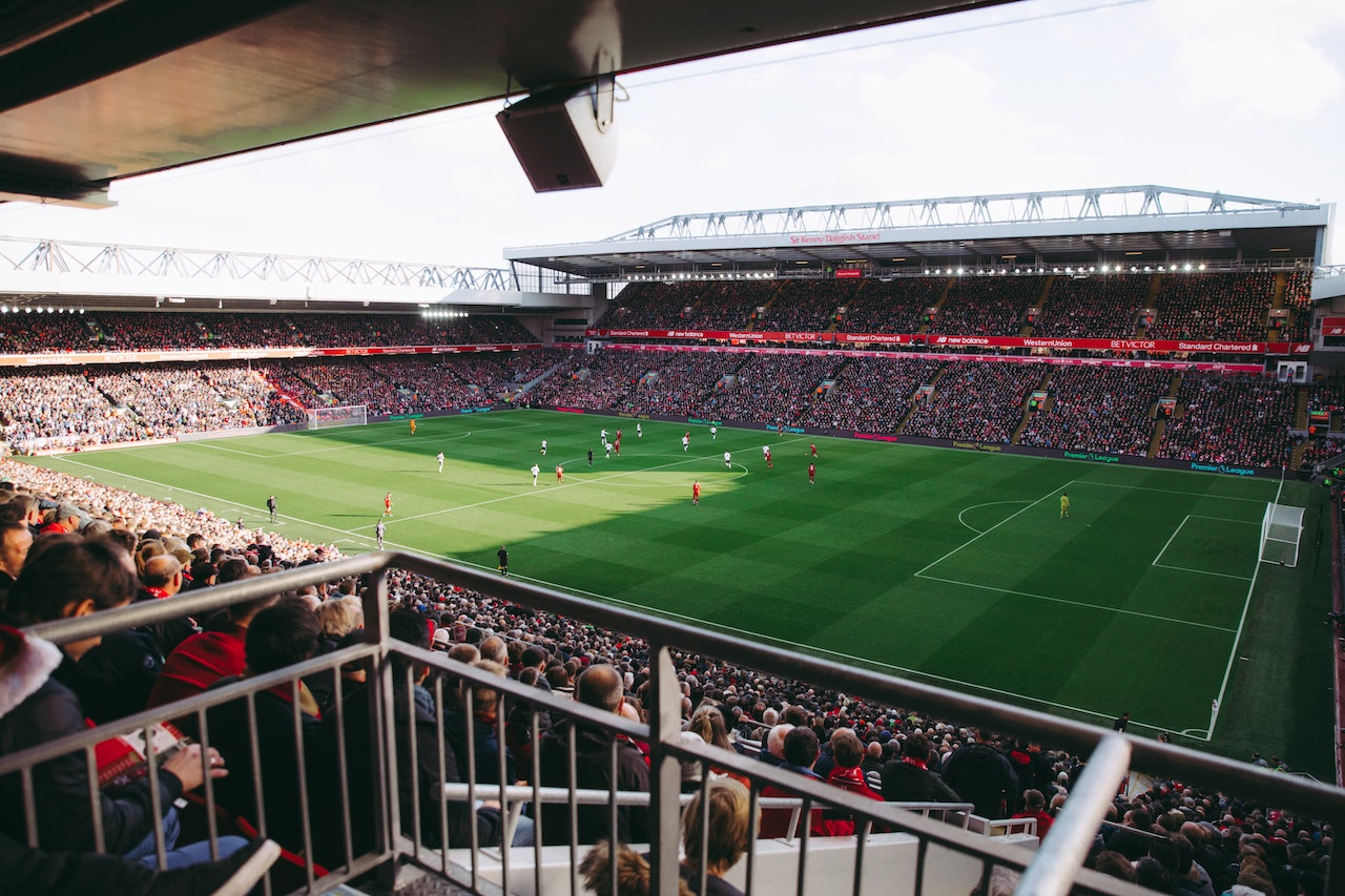 crowd watching a football game in a stadium