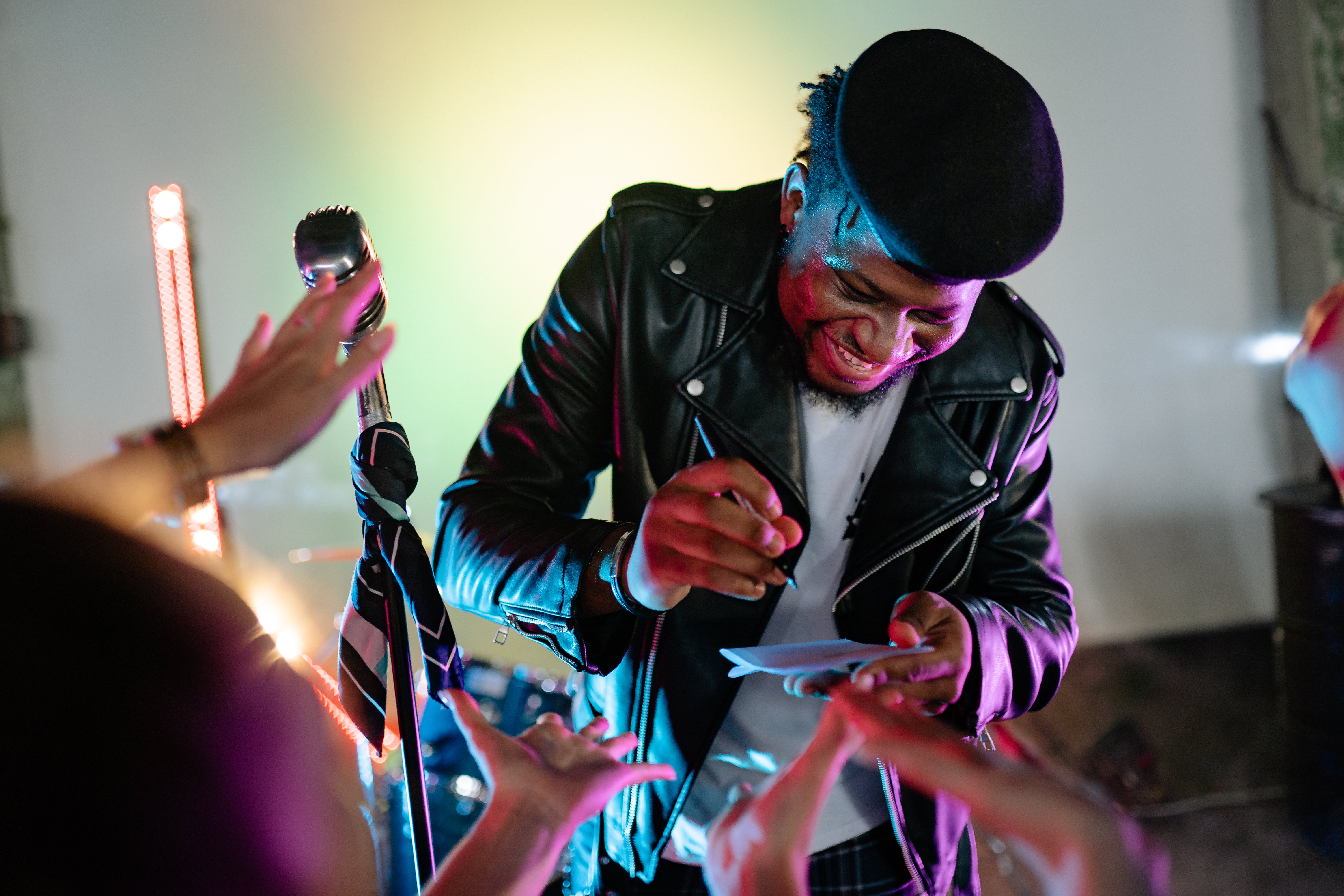 man signing an album